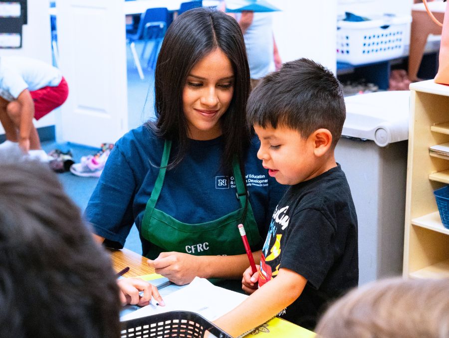 Kayla Juarez works with a child in the Child and Family Research Center.