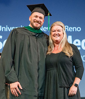 Adam Serfoss getting hooded on stage.