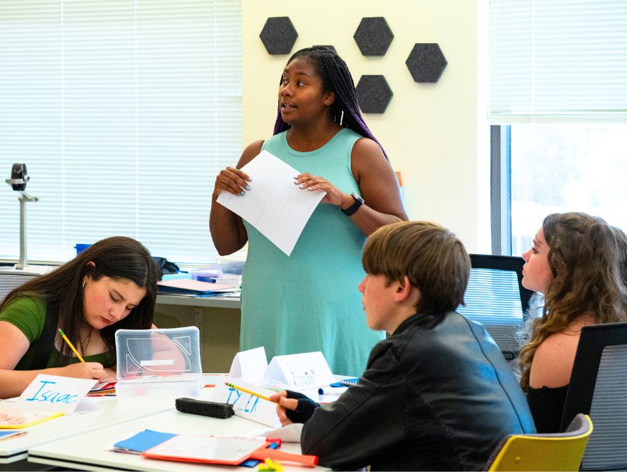 Students in a classroom with their instructor.