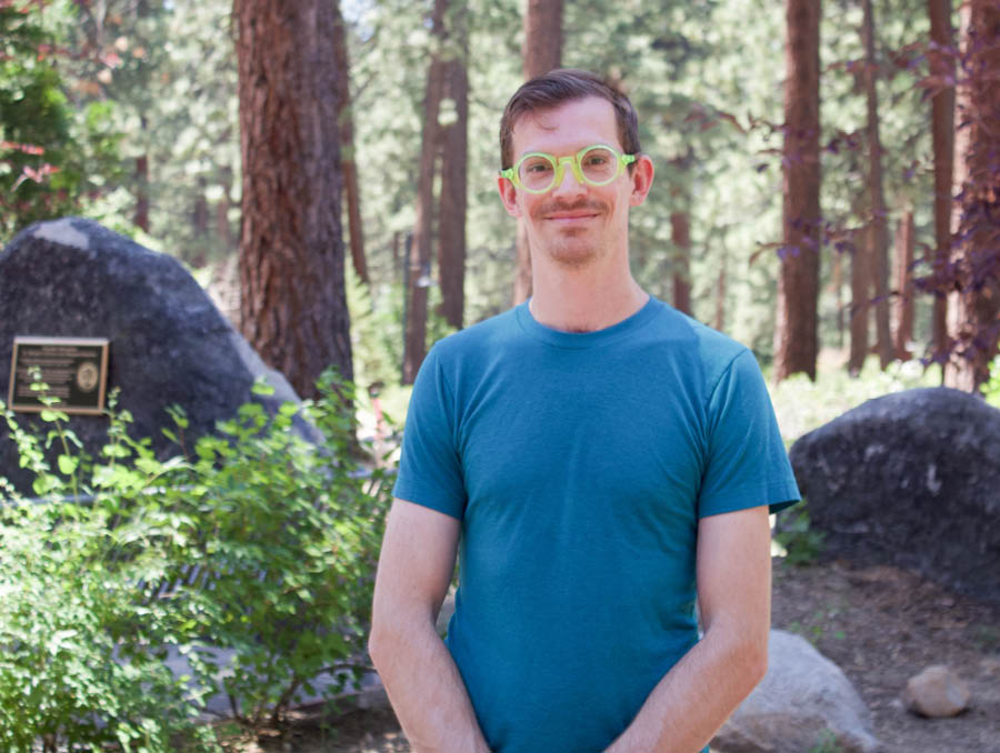Headshot of Tyler Calkin in the forest.