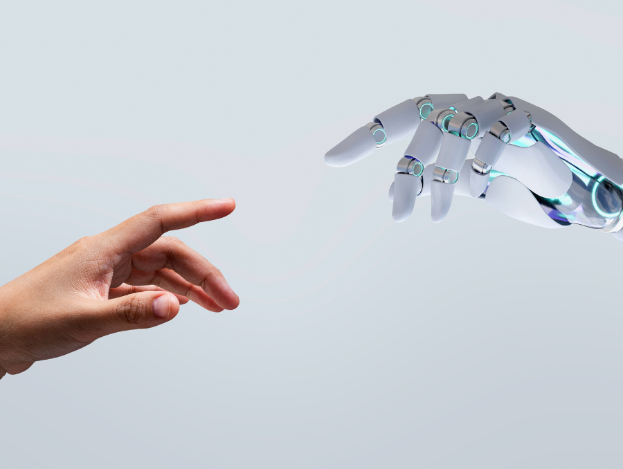 A human hand going to touch a robot hand.