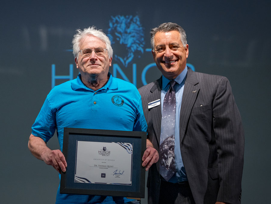 Thomas Quint and President Brian Sandoval pose for a photo as Quint holds a framed certificate.