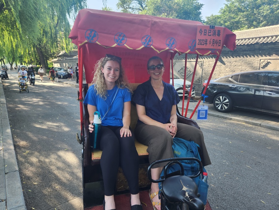 Two women sitting in a tuk tuk.