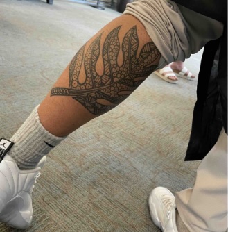 Caden Salois' breadfruit tattoo on his calf.