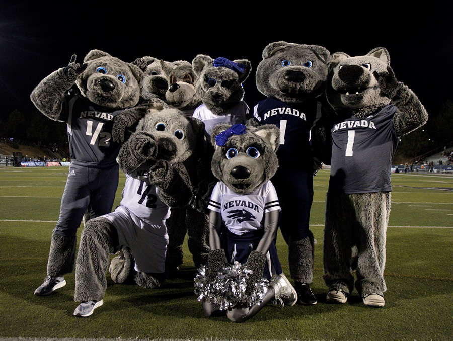 Nevada Wolf Pack mascots posing in a group photo on the Mackay Stadium field.