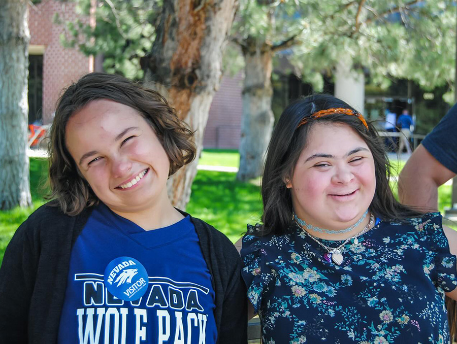 Two Path to Independence summer camp participants, Lila Barber and Julia Layosa, smile outside the College of Education and Human Development.