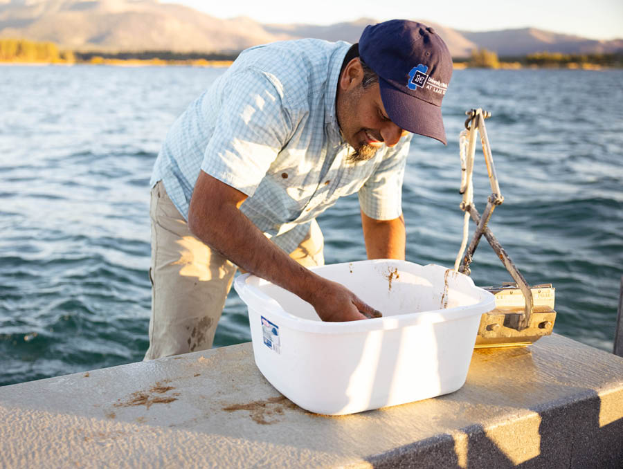 Sudeep Chandra, a researcher at the University of Nevada, Reno, looks for invasive species after using a device to scoop up a sample of sediment from the bottom of Lake Tahoe.
