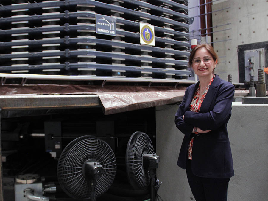 Elnaz Seylabi stands in front of a large testing structure.
