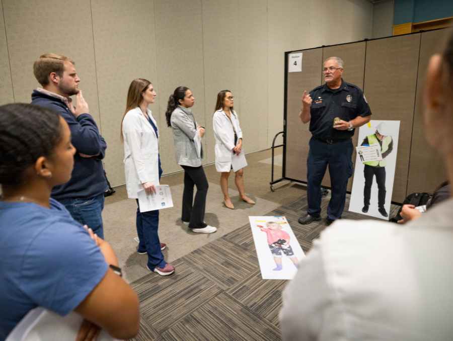 A REMSA facilitator instructs participants,
