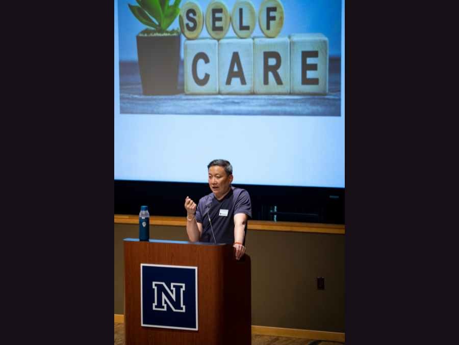 An Orvis School of Nursing professor speaking at a podium.