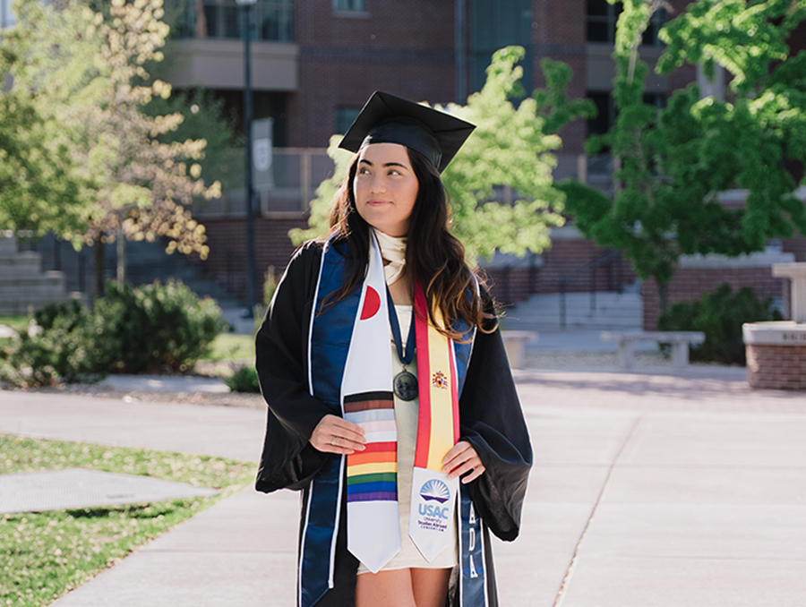Kelly Mader poses for graduation photo on campus.
