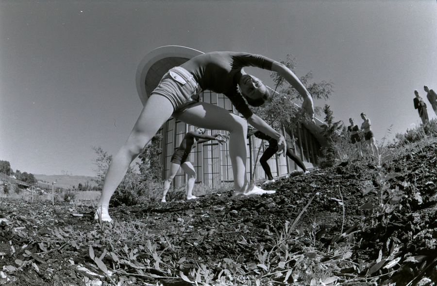 Modern dancers pose in front of the planetarium.