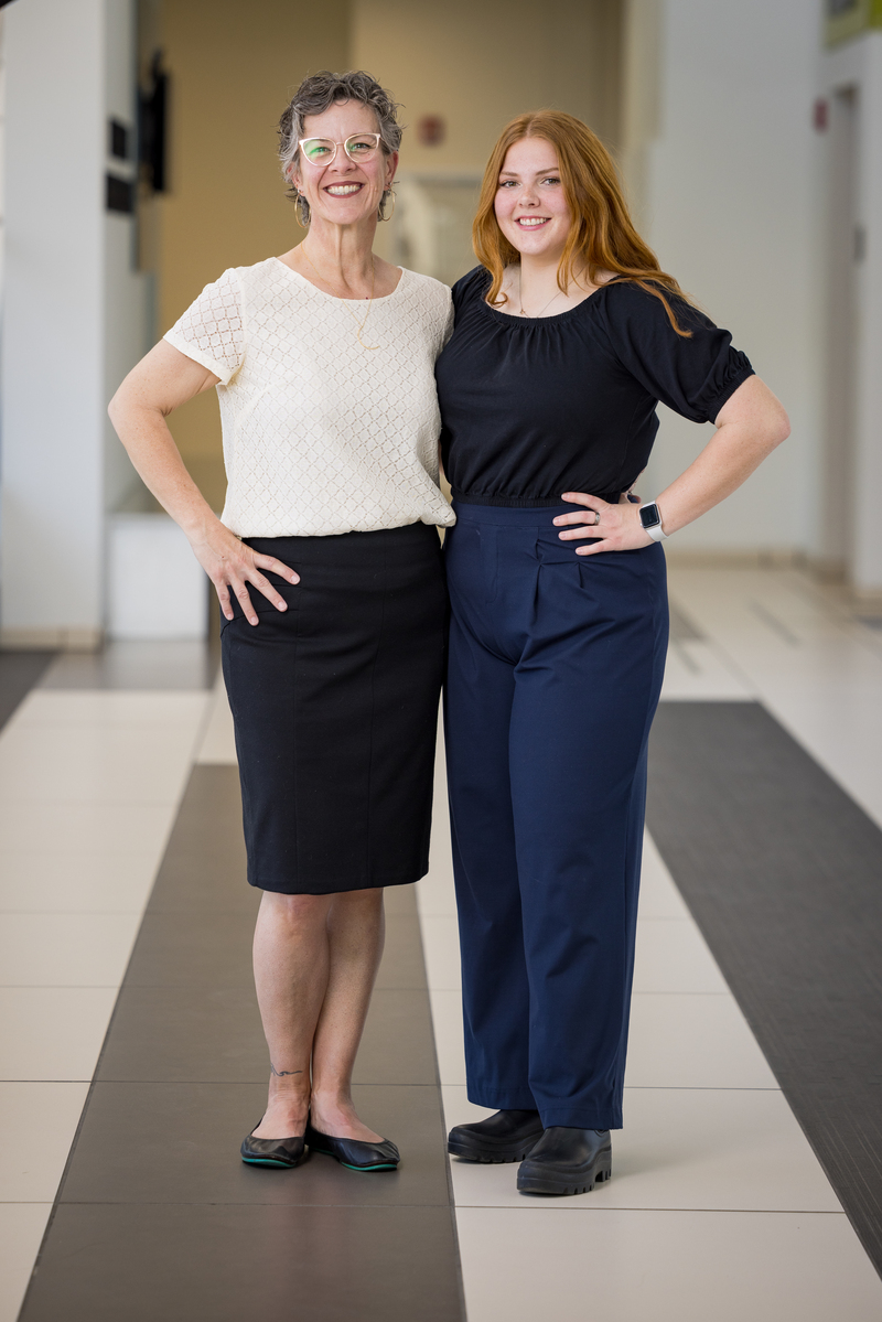Mentor Rachael Walden with Scholar Allison K Frost posing in a hallway.