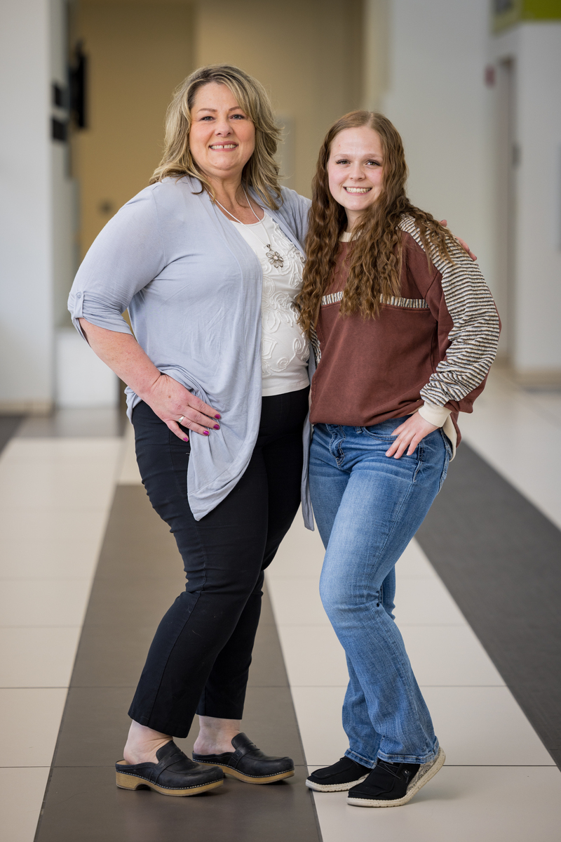 Mentor Kim Buell with Scholar Mackenzie Baker posing in a hallway.