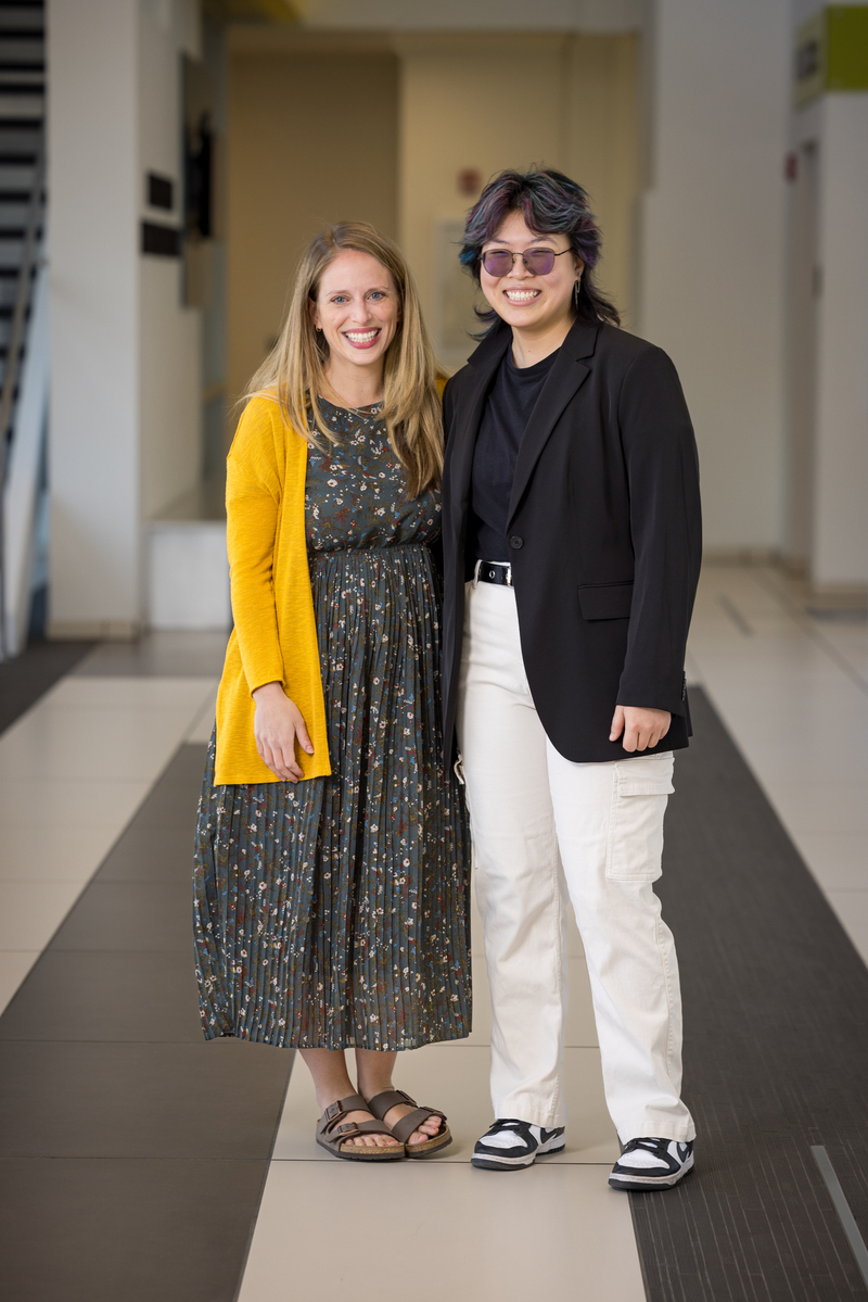 Mentor Lucy Cummings with Scholar Rin Xiong posing in a hallway.