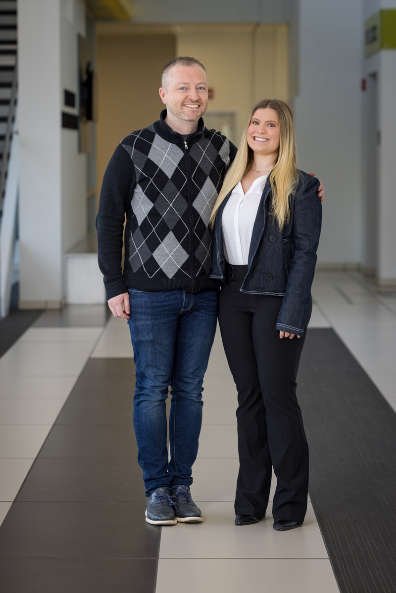 Mentor Eric Crosbie with Scholar Sierra Wilson posing in a hallway.