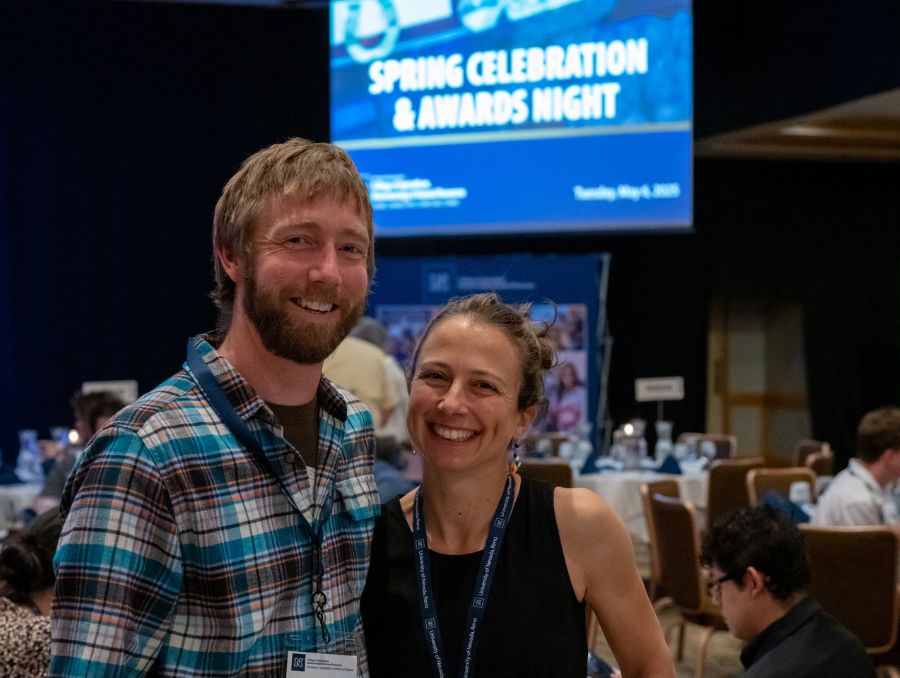 A smiling man and woman pose for a picture.