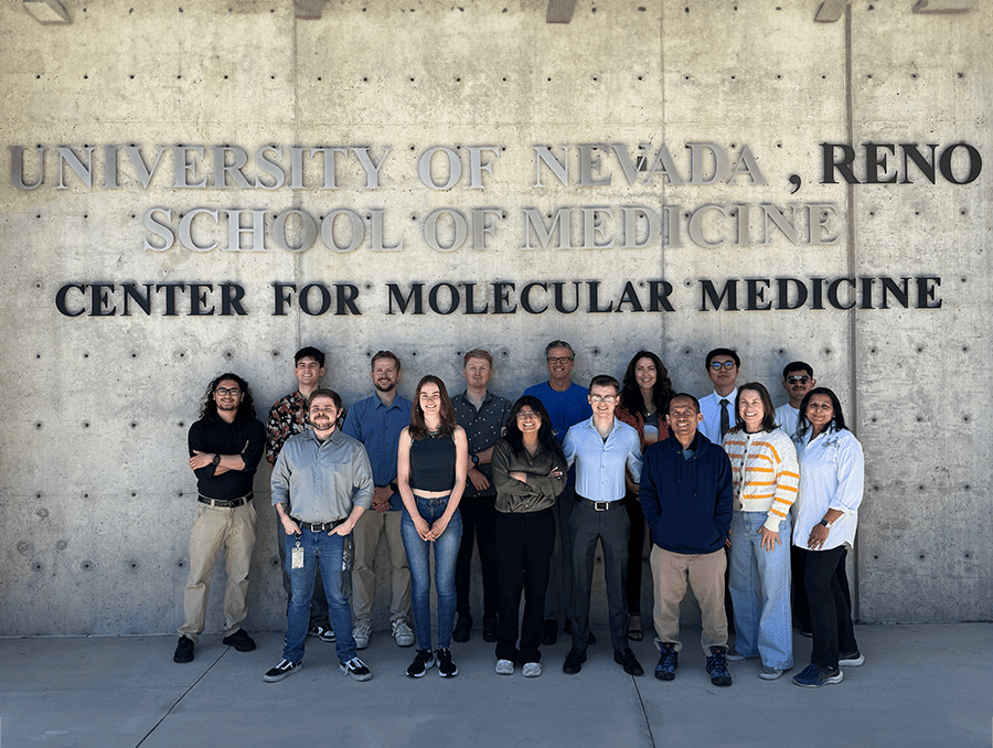 AuCoin Lab members standing outside of the University of Nevada, Reno Center for Molecular Medicine building.