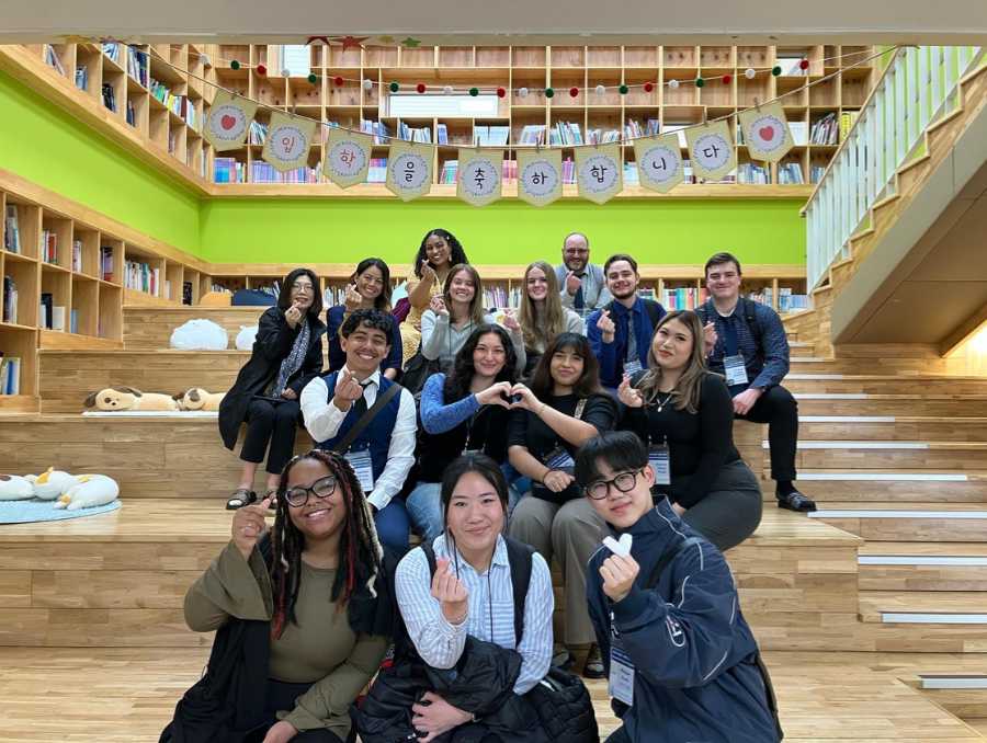 A group of students in South Korea sitting on steps.