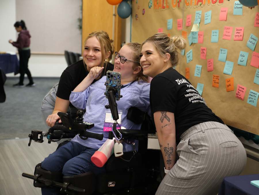 Staff members of Amplify Life, Taylor Cheney and Kennedy Martinez with summit attendee in the middle, Shelby Benzing.