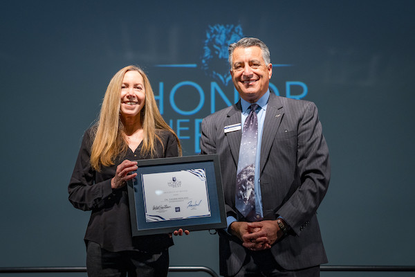 Professor Fridland with President Sandoval on stage at Honor the Best.
