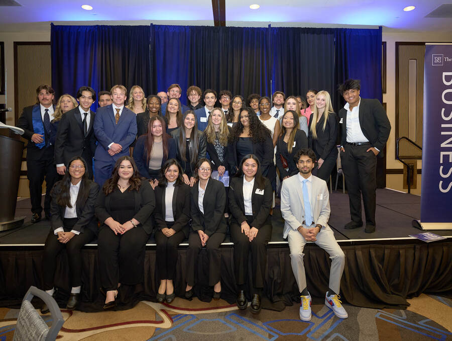 Business Student Council poses together in a group photo on stage at the annual Honors and Awards Banquet.