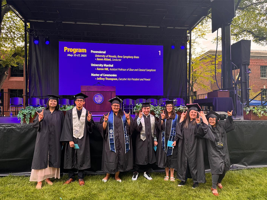 P2I graduates pose in front of the graduation stage.