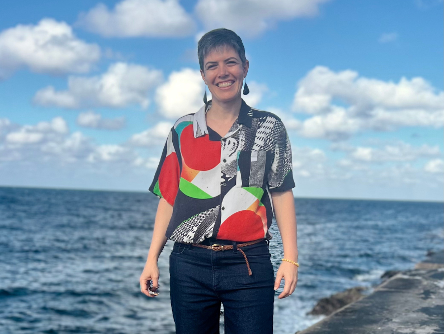 Ruthie Meadows standing in front of the ocean.