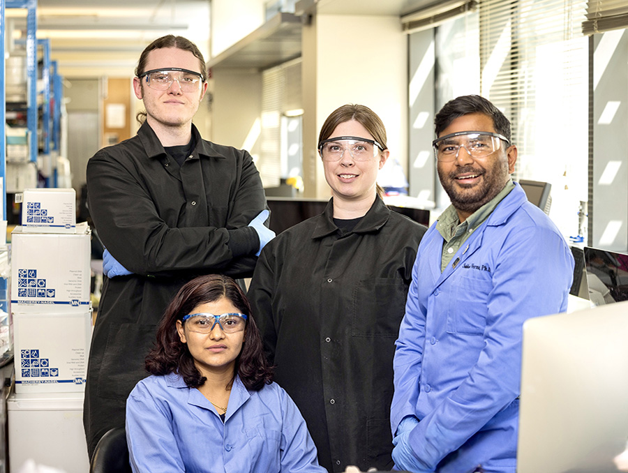 Lab members dressed in personal protective equipment.