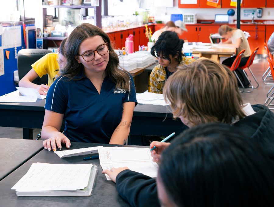 Cassie Eckroth helping a student in the classroom.
