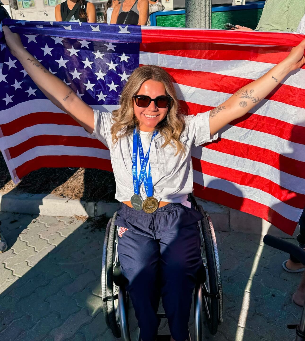 Cassie Eckroth in a wheelchair with a gold medal.