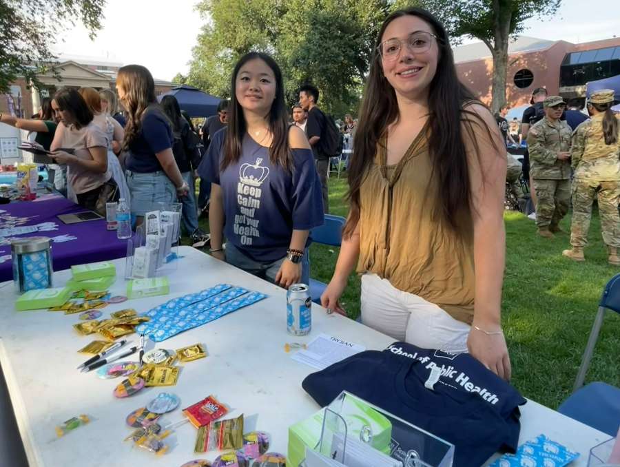Claire Lin from the Condom Collective, and a Public Health Coalition representative at a tabling event