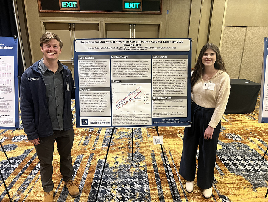 Douglas Collins and Erin Lovell standing next to their research poster.