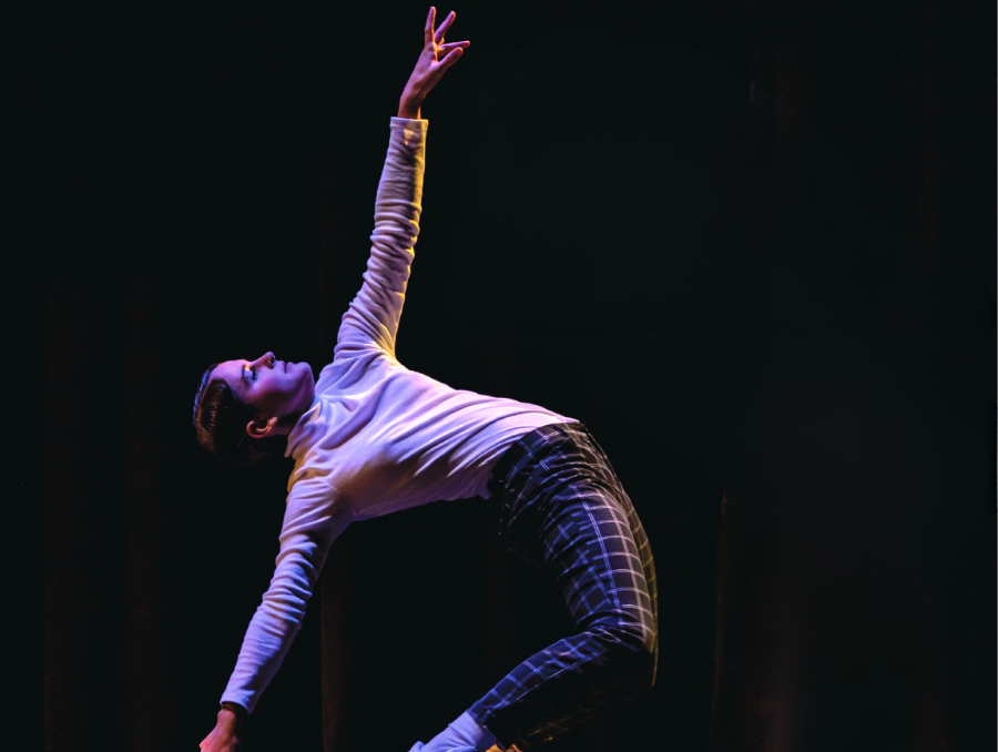 A dancer on stage, performing. 