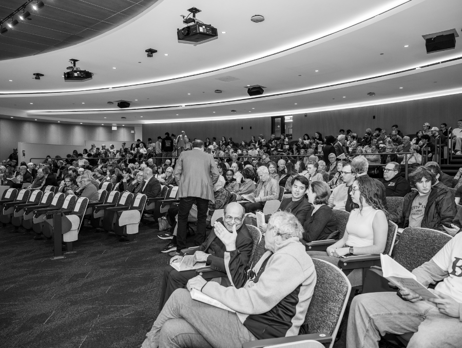 A crowd of people sitting in a lecture hall.
