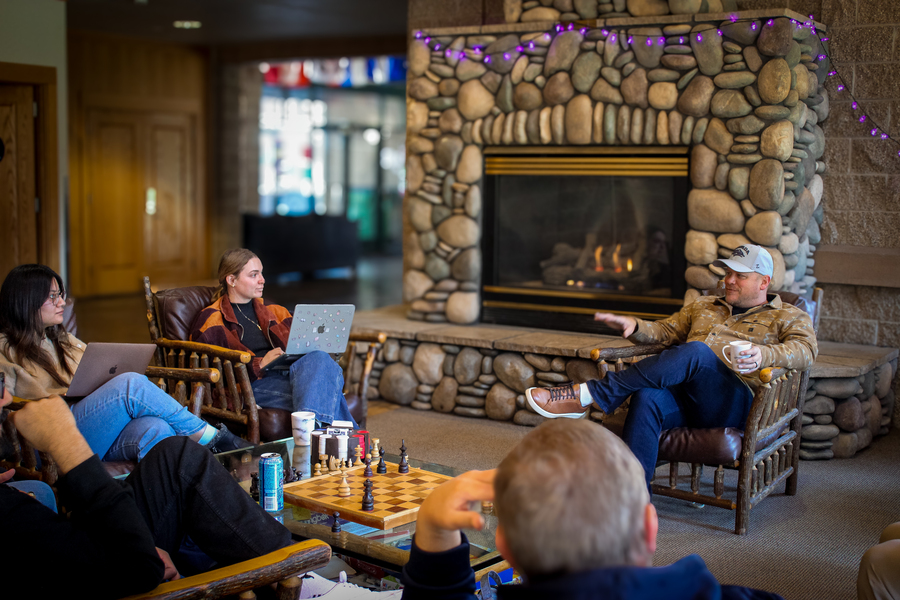 Professor and students discuss innovation fireside. 