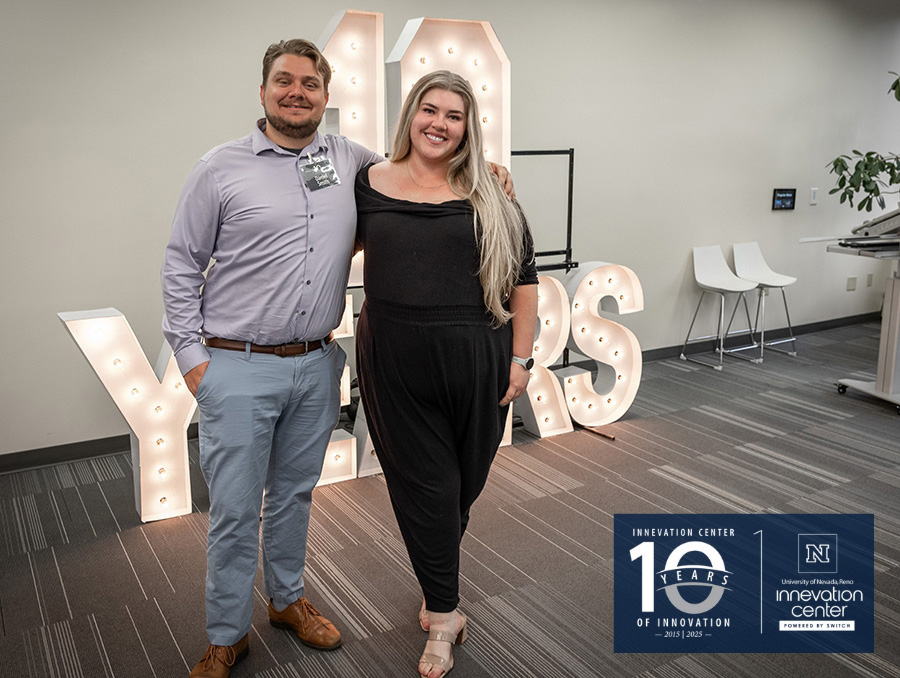 Two individuals smiling and standing beside large letters that spell "10 Years" in a room celebrating 10 years of UNR's Innevation Center.