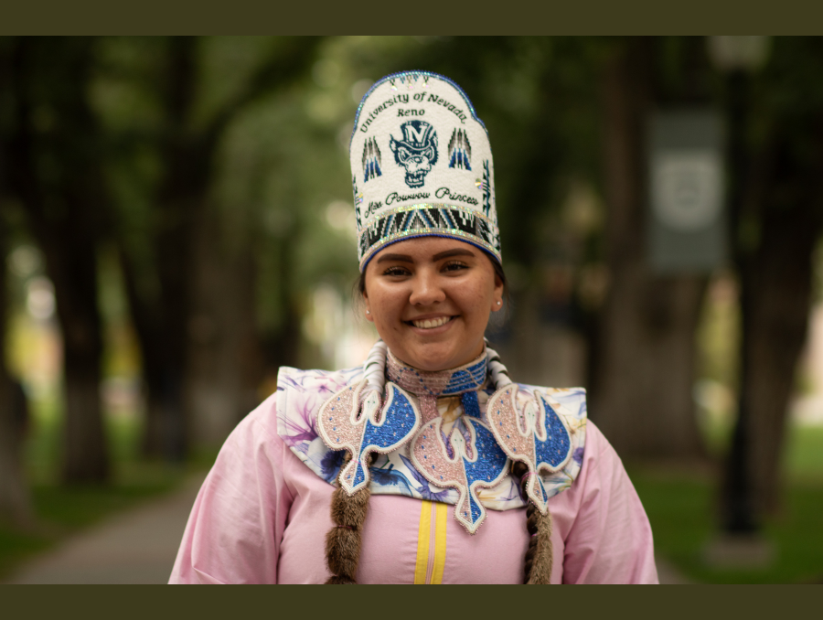 Riata Palmer, wearing traditional clothing including a beaded crown that reads "University of Nevada, Reno, Miss Powwow Princess."