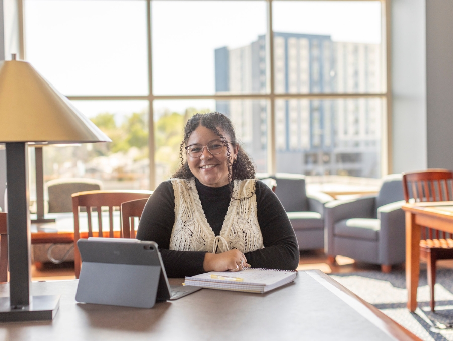 A student in the library with her iPad.