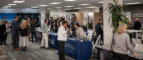 Member fair with people visiting various booths during the Innevation Center 10-year celebration.