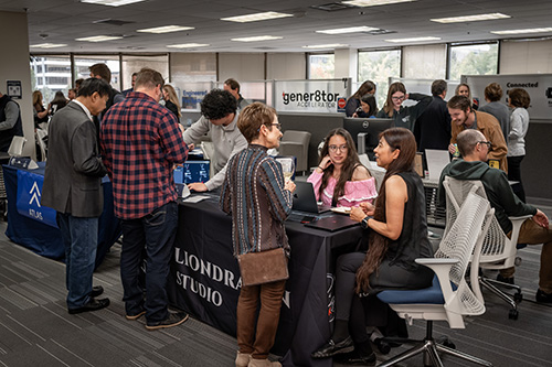 Attendees interacting at various booths during UNR's Innevation Center 10-year celebration.