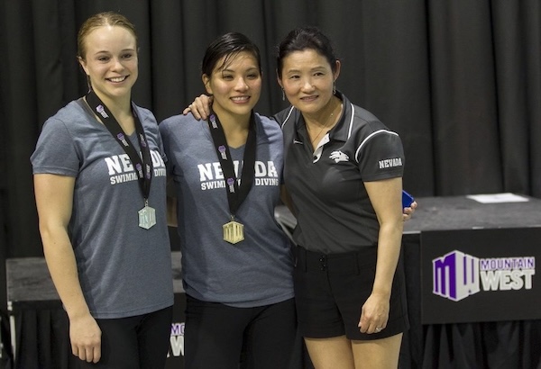 Krysta Palmer celebrating her Mountain West Diving medal with teammate an coach..