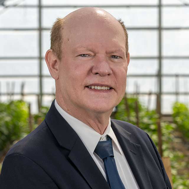 Bill Payne in a hoop house.