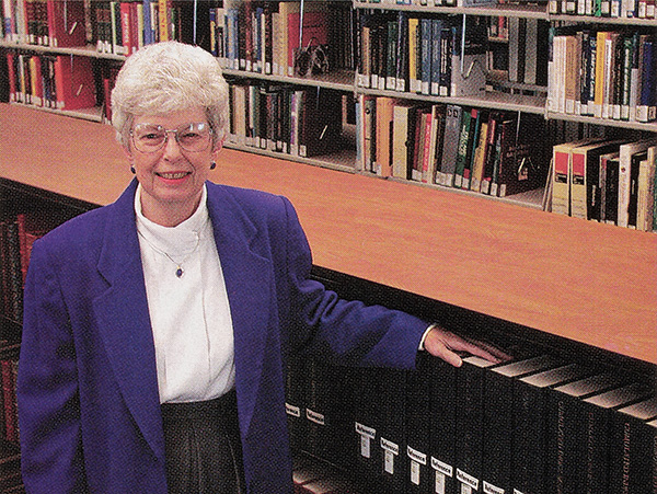 Portrait of Joan Zenan in the stacks inside Savitt Medical Library.