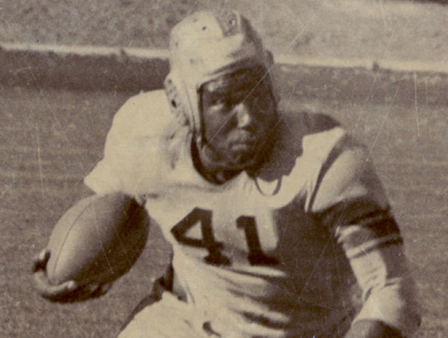 Marion Motley running with football in hand.