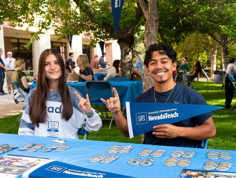 Two NevadaTeach students at a table.