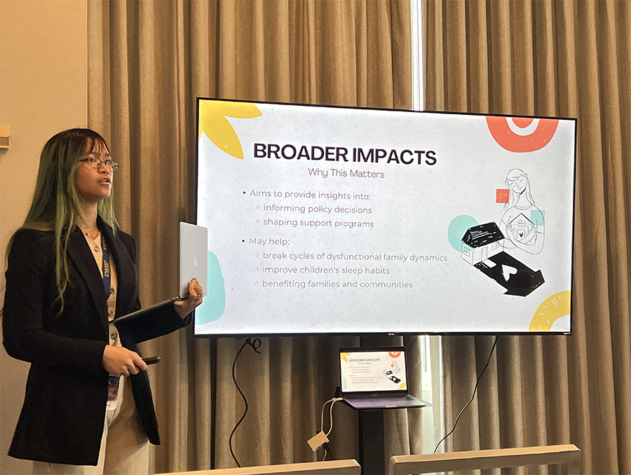 A person presenting a slideshow titled "Broader Impacts" about the significance of insights into shaping policy and supporting programs. The slide includes bullet points and related graphics.