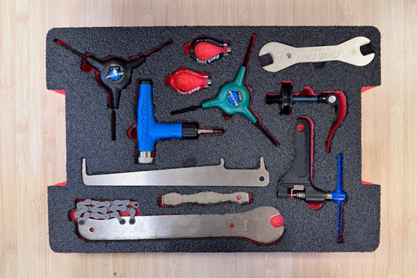An overhead view of a piece of foam with cutouts for various tools.