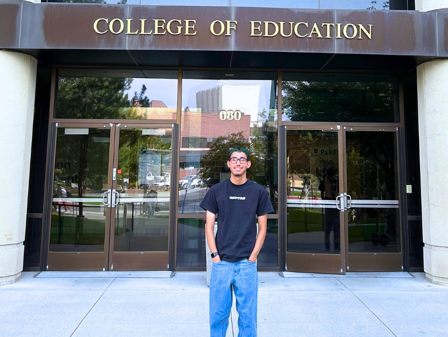 Fabian Gomez standing in front of the College of Education & Human Development