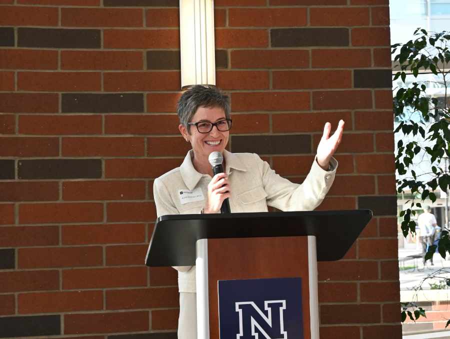 Katie Elhman, Ph.D., standing at a podium.